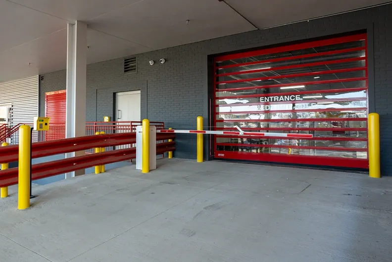 Secure indoor storage entrance with roll-up gate and controlled access area